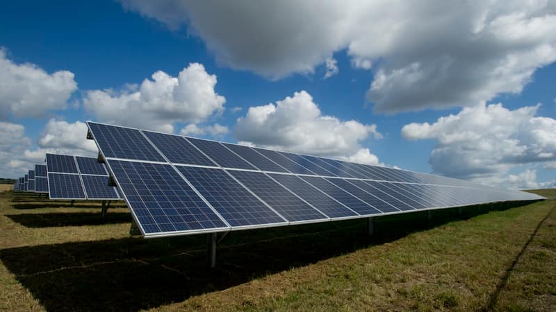 Solar panel array stretching across an Ethiopian landscape under clear blue sky