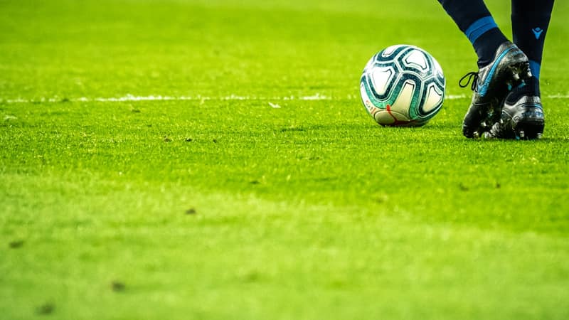 Football stadium in Africa packed with fans and vibrant green pitch